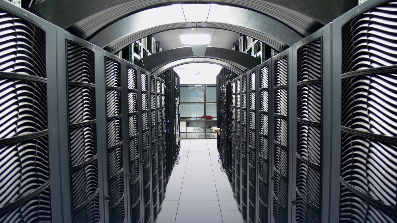 An aisle between server racks in a data centre