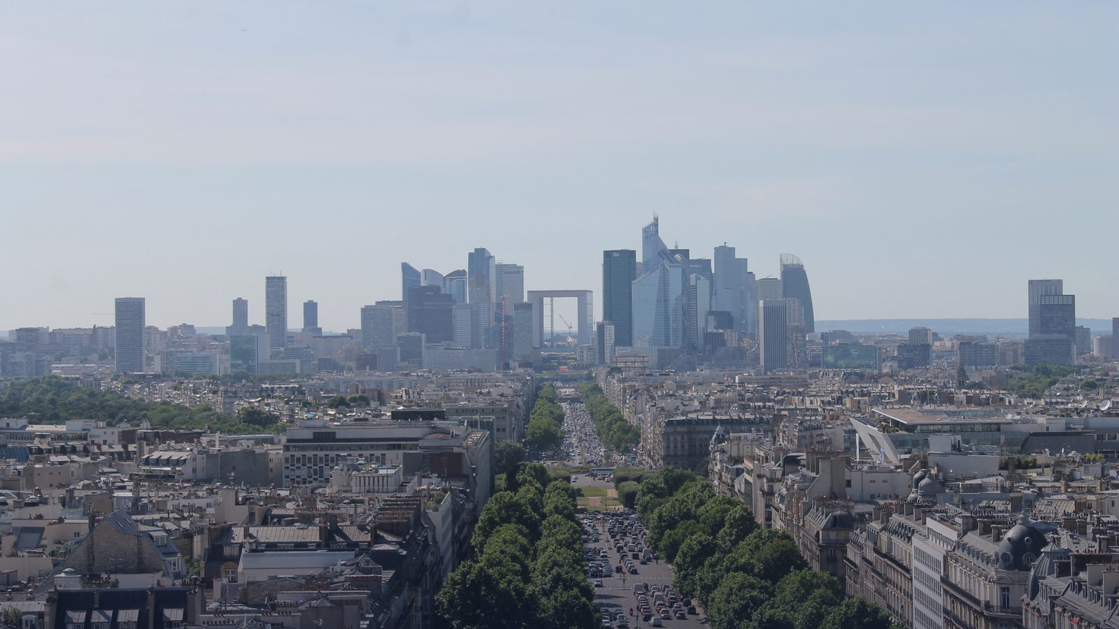 The towers of La Défense seen down a Paris avenue