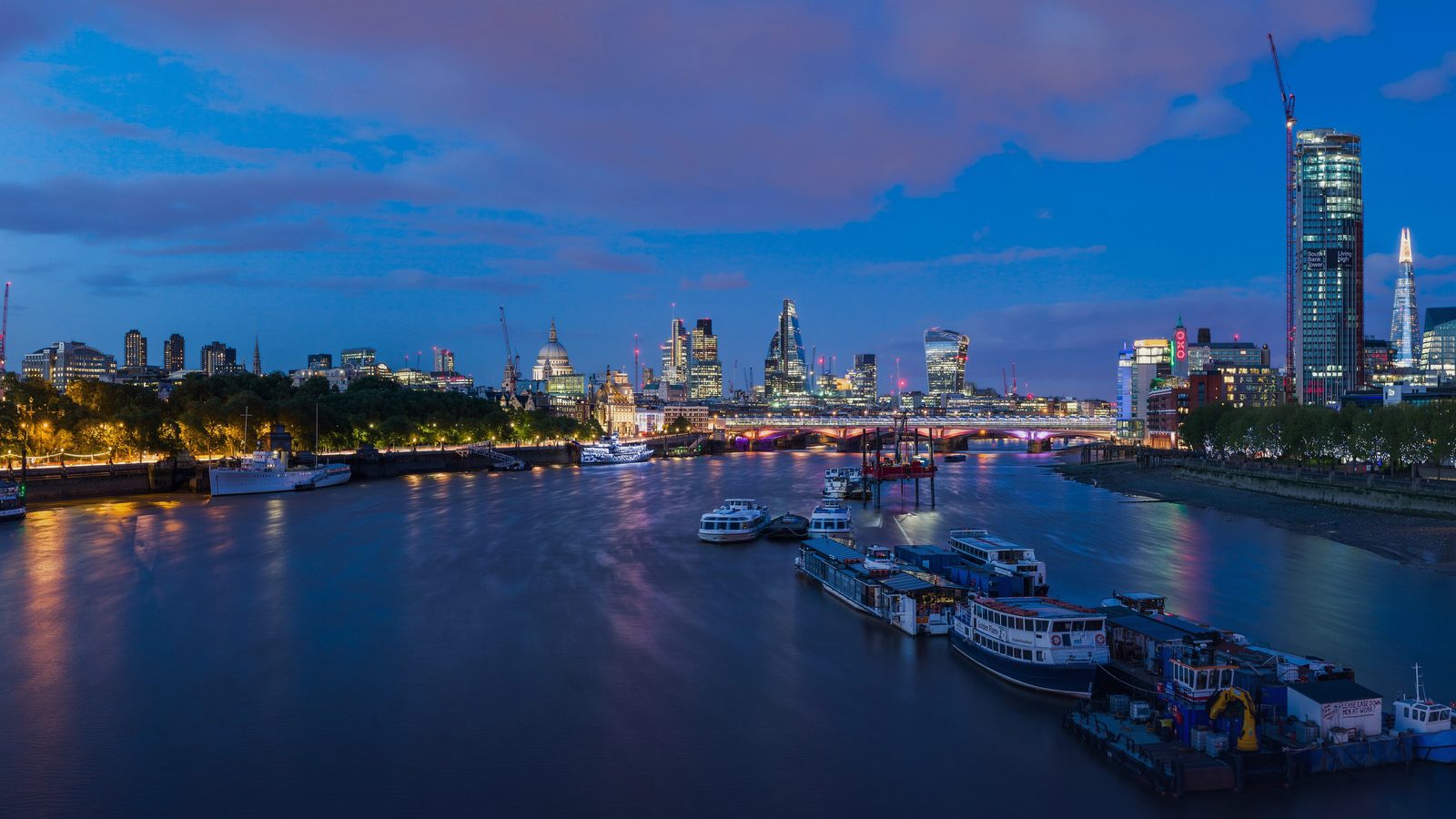 London's skyline along the Thames at dusk from Waterloo Bridge