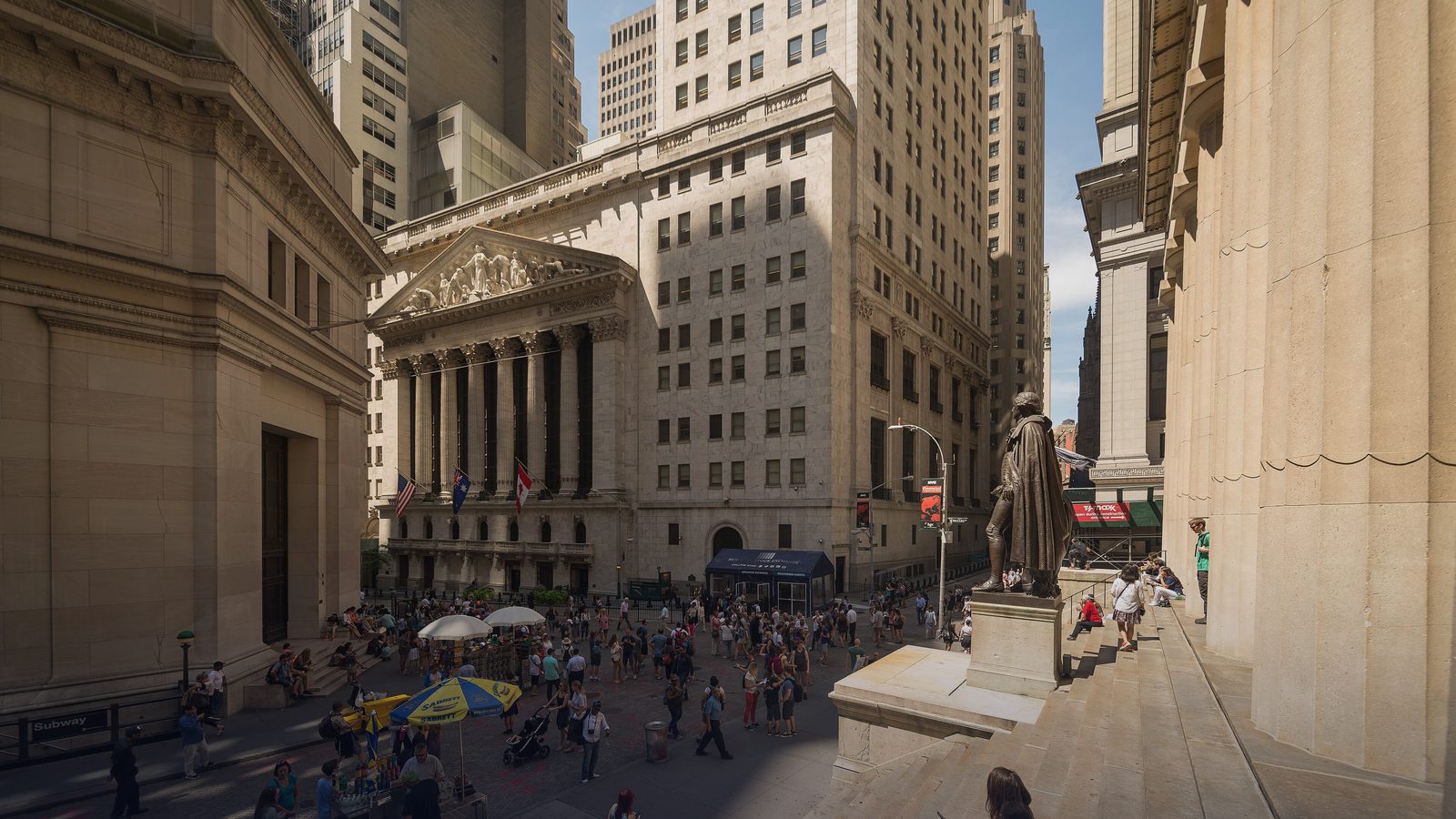 The corner of Wall Street and Broad Street, with the New York Stock Exchange and Federal Hall